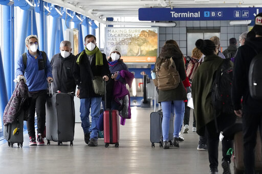 FILE - Travelers walk through Terminal 1 at O'Hare International Airport in Chicago, on Dec. 30, 2021. The websites for some major U.S. airports went down early Monday, Oct. 10, 2022, in an apparent coordinated denial of service incident, although officials said flights were not affected. (AP Photo/Nam Y. Huh, File)