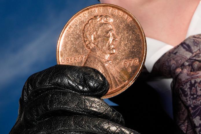 A person holds a giant penny at a mock funeral for the coin, which was discontinued earlier this year, Saturday, Dec. 20, 2025, in front of the Lincoln Memorial in Washington. (AP Photo/Julia Demaree Nikhinson)