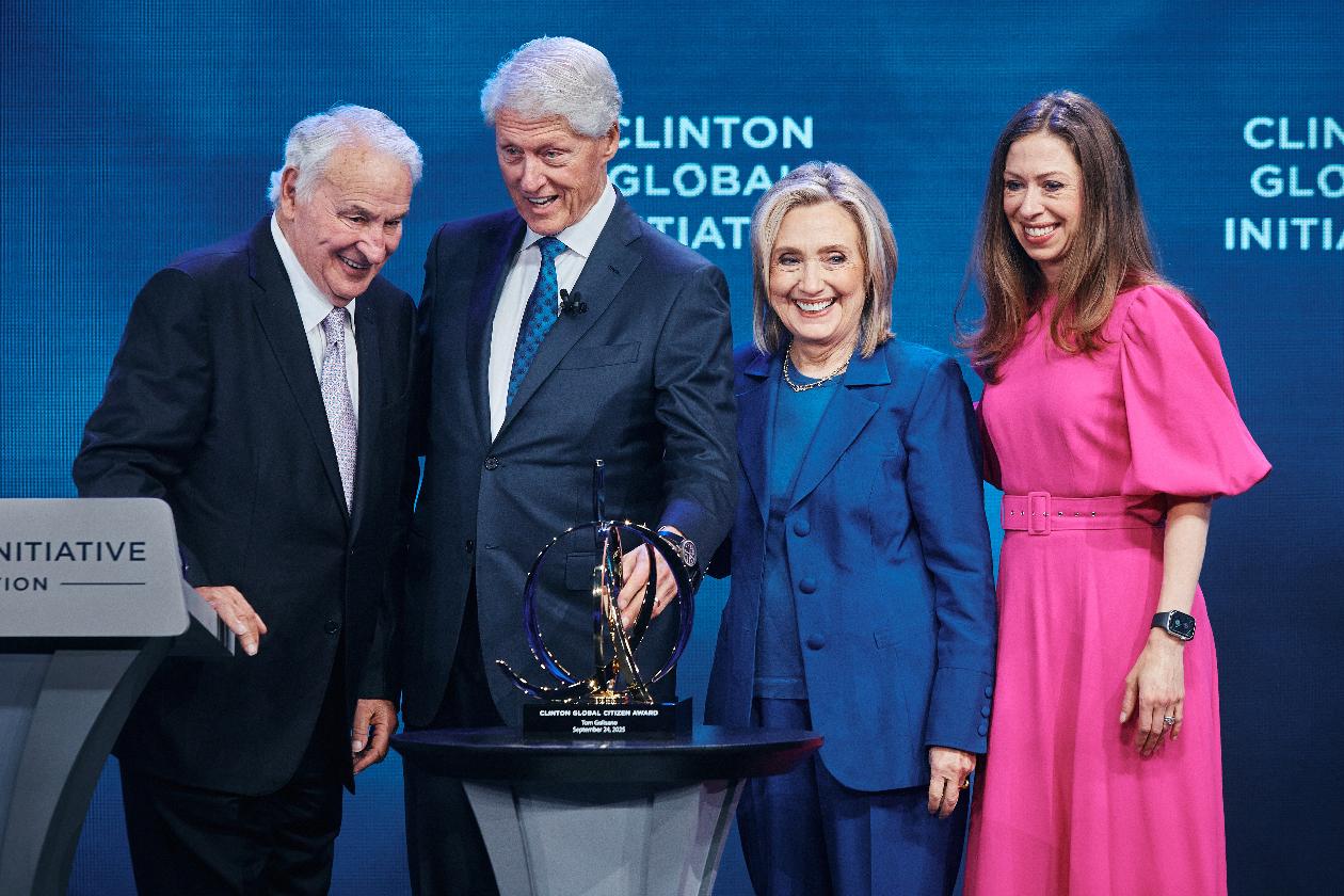 Former U.S. President Bill Clinton, second left, smiles with American businessman Tom Golisano, left, as he awards him with "The Clinton Global Citizen Award" next to former United States Secretary of State Hillary Clinton, second right, and Chelsea Clinton during the Clinton Global Initiative on Wednesday, Sept. 24, 2025, in New York. (AP Photo/Andres Kudacki)