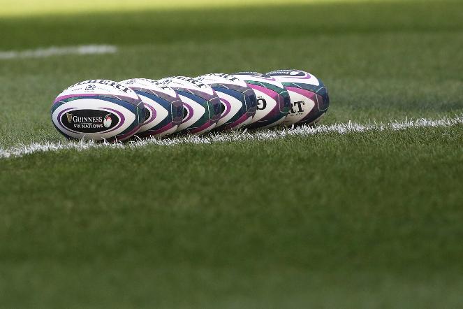 FILE - Rugby balls are lined up on the pitch prior to the start of the rugby union international match between Scotland and Italy in Edinburgh, Scotland, on March 20, 2021. (AP Photo/Scott Heppell, File)