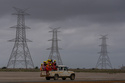 FILE - Workers travel in a vehicle toward the construction site of Adani Green Energy Limited's Renewable Energy Park in the salt desert of Karim Shahi village, near Khavda, Bhuj district near the India-Pakistan border in the western state of Gujarat, India, on Sept. 21, 2023. (AP Photo/Rafiq Maqbool, File)