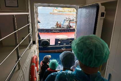 Passengers are being disembarked from the hantavirus-stricken cruise ship MV Hondius at the port of Granadilla in Tenerife, Canary Islands, Spain, Sunday, May 10, 2026. (AP Photo)