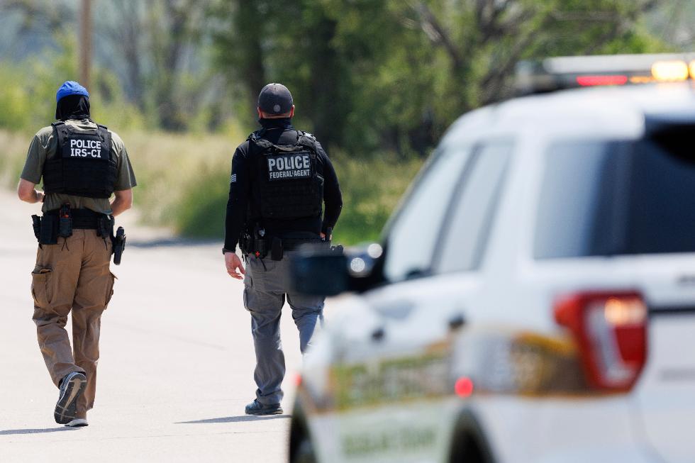 Federal agents are seen near Glenn Valley Foods in Omaha, Neb., Tuesday, June 10, 2025. (Nikos Frazier/Omaha World-Herald via AP)