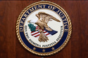 FILE - The seal of the Dept of Justice is shown on the podium, Aug. 1, 2023, at an office of the Department of Justice in Washington. (AP Photo/J. Scott Applewhite, File)