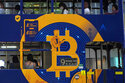 FILE - This May 12, 2021, file photo shows an advertisement for the cryptocurrency Bitcoin displayed on a tram in Hong Kong. Cryptocurrencies have surged to nearly $2.5 trillion in total value, rivaling the size of G7 economies like Canada’s and Italy’s, with more than 200 million users. At that size, it’s simply too large for the financial establishment to ignore. Firms that cater to the world’s wealthiest families are increasingly putting some of their fortunes into crypto. Hedge funds are trading Bitcoin, which has big-name banks starting to offer them services around it. And in the latest milestone for the industry, an easy-to-trade fund tied to Bitcoin began trading on Tuesday, Oct. 19, 2021. (AP Photo/Kin Cheung, File)