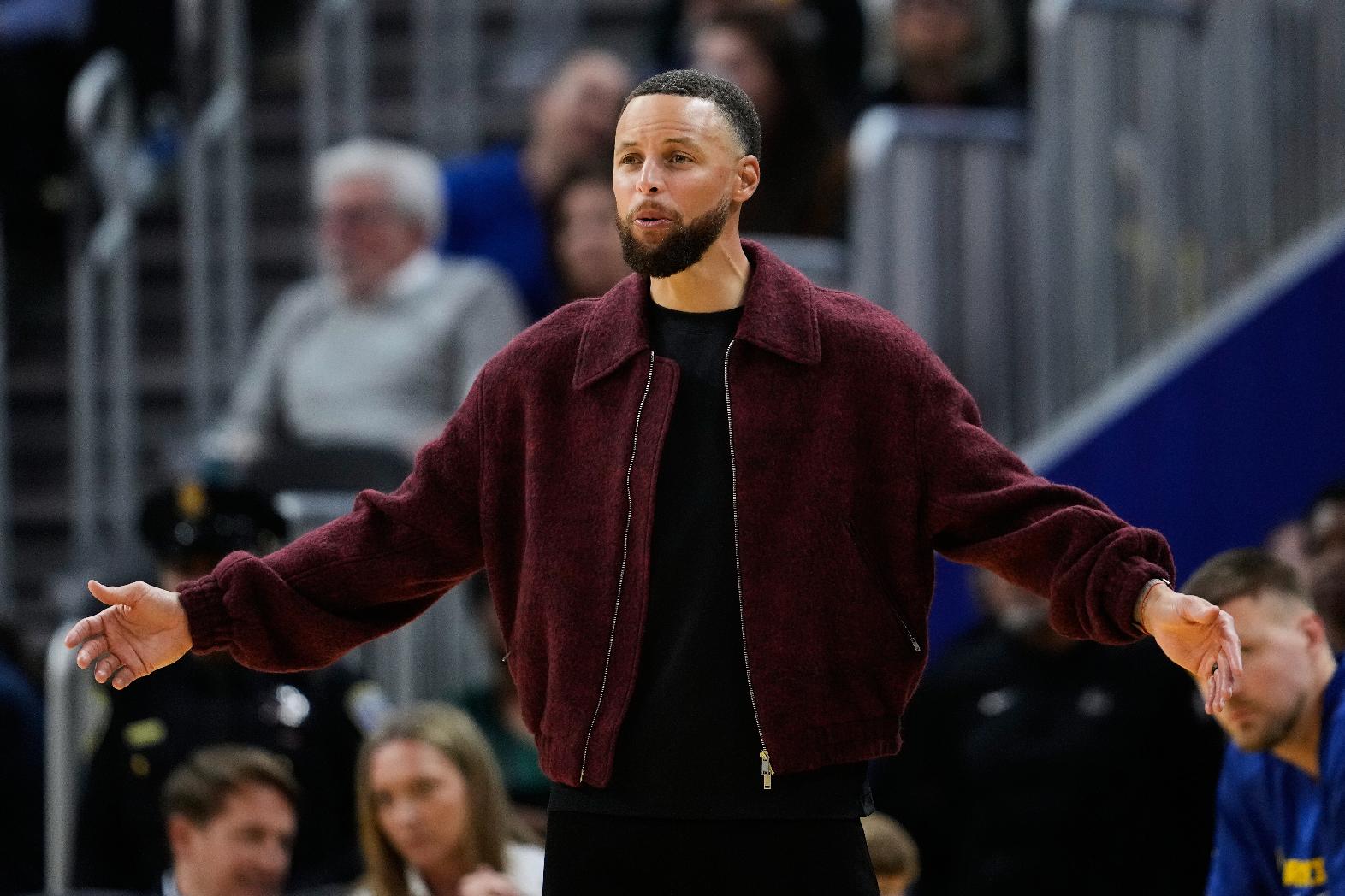 Golden State Warriors' Stephen Curry reacts from the bench during the second half of an NBA basketball game against the Minnesota Timberwolves, Friday, March 13, 2026, in San Francisco. (AP Photo/Godofredo A. Vásquez)