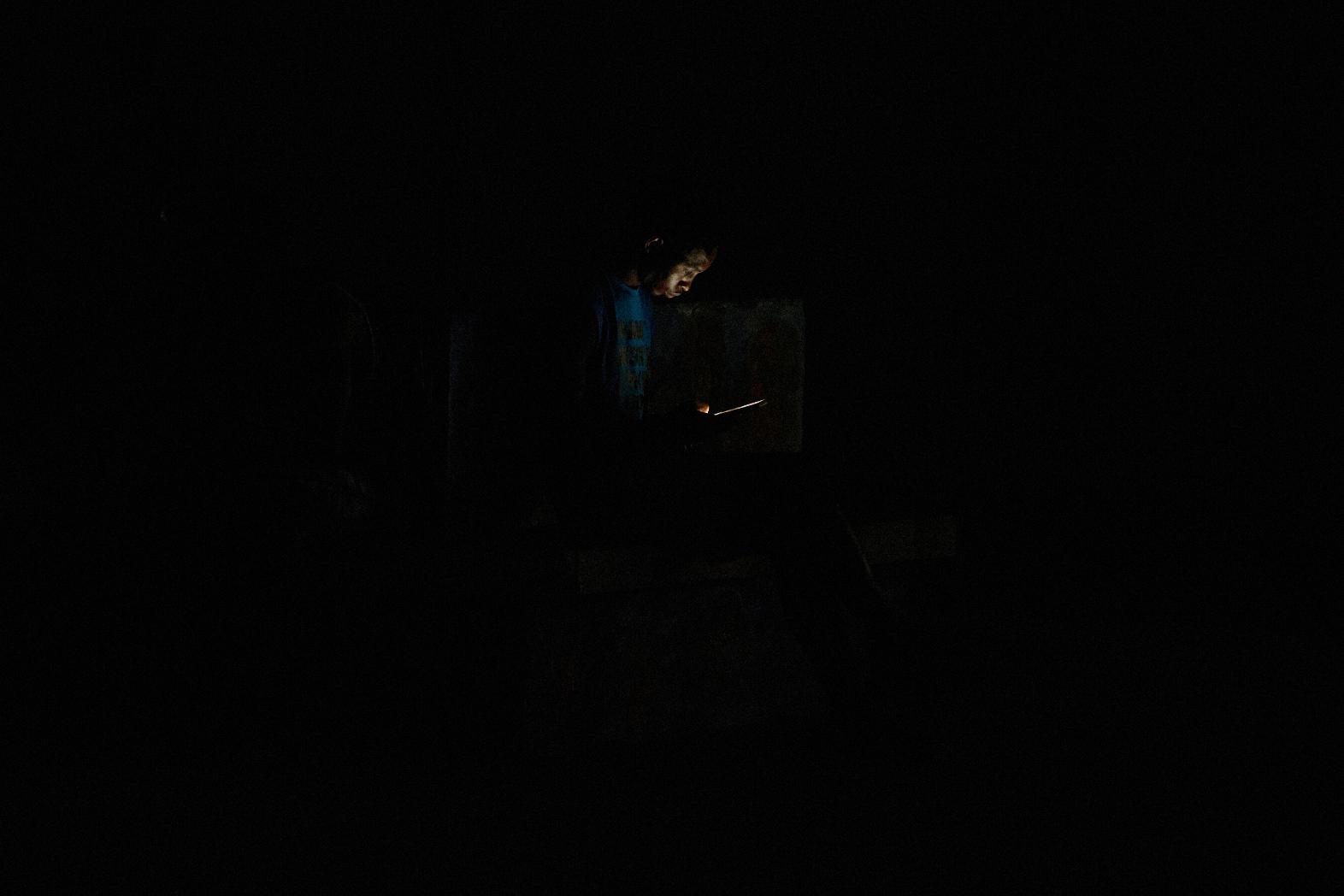 A man looks at his cell phone during a blackout in Havana, Cuba, Monday, July 6, 2026. (AP Photo/Ramon Espinosa)