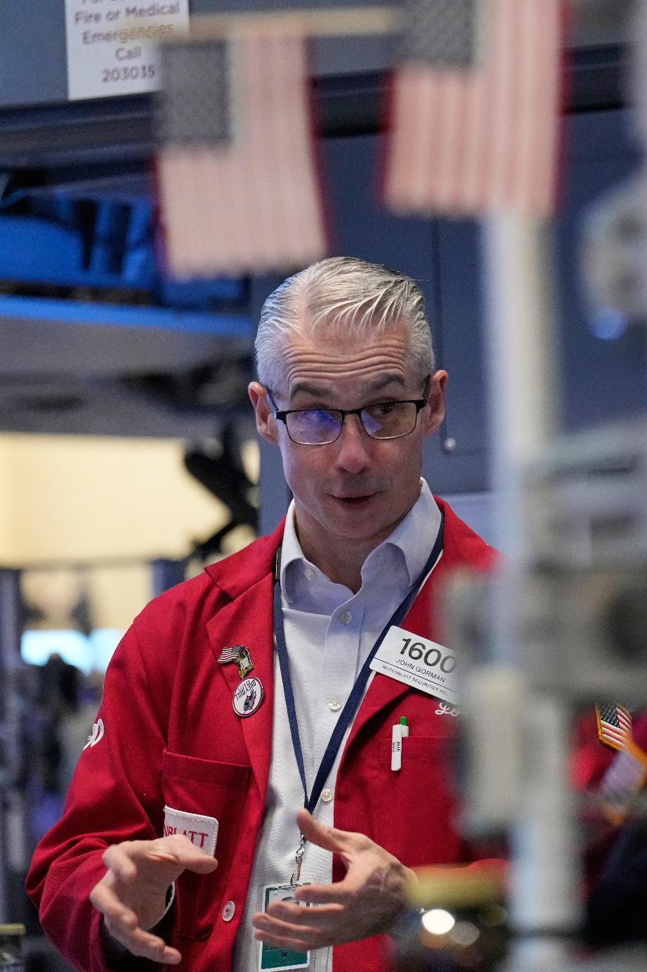 John Gorman works on the floor at the New York Stock Exchange in New York, Thursday, March 19, 2026. (AP Photo/Seth Wenig)