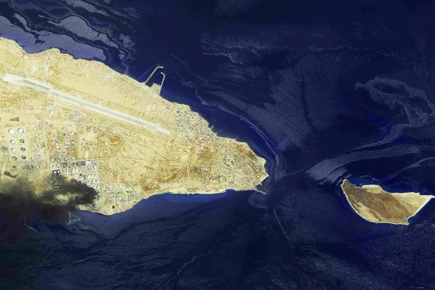 This image from an Airbus Defence and Space's Pléiades Neo satellite shows a fire at an oil refinery on Iran’s Lavan Island, left, and an oil slick in the waters of the Persian Gulf around Shidvar Island, right, April 10, 2026. (Airbus Defence and Space© via AP)