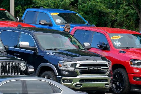 File - A man walks through a used car lot in Pittsburgh on Thursday, Sept. 29, 2022. On Thursday, the Labor Department reports on U.S. consumer prices for December. (AP Photo/Gene J. Puskar, File)