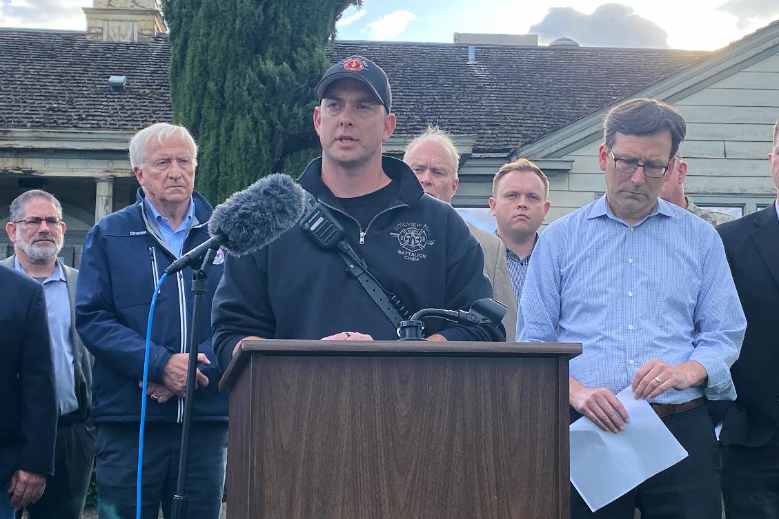 Longview Fire Department Battalion Chief Matt Amos speaks at a press conference in Longview, Wash., Tuesday, May 26, 2026, at the site of a paper mill where a chemical tank failure killed at least one person and left others unaccounted for. (AP Photo/Claire Rush)