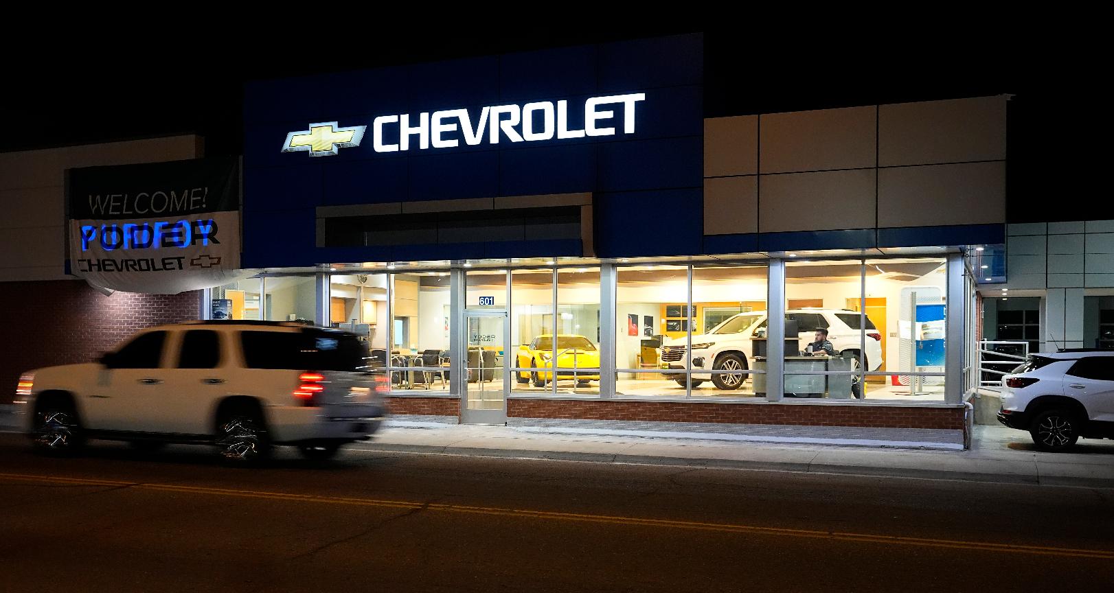 FILE- A a vehicle passes a Chevrolet dealership in Fort Lupton, Colo. Many car shoppers neglect a key factor that can help save money: getting the best value for their trade-in vehicle. (AP Photo/David Zalubowski)