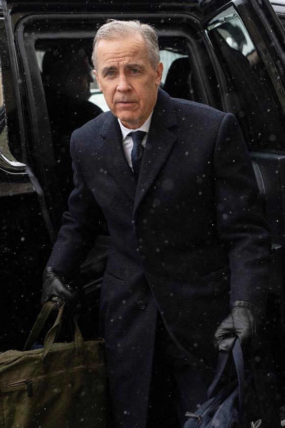 Canadian Prime Minister Mark Carney arrives by motorcade to Parliament Hill in Ottawa, Tuesday, Jan. 27, 2026. (Adrian Wyld/The Canadian Press via AP)