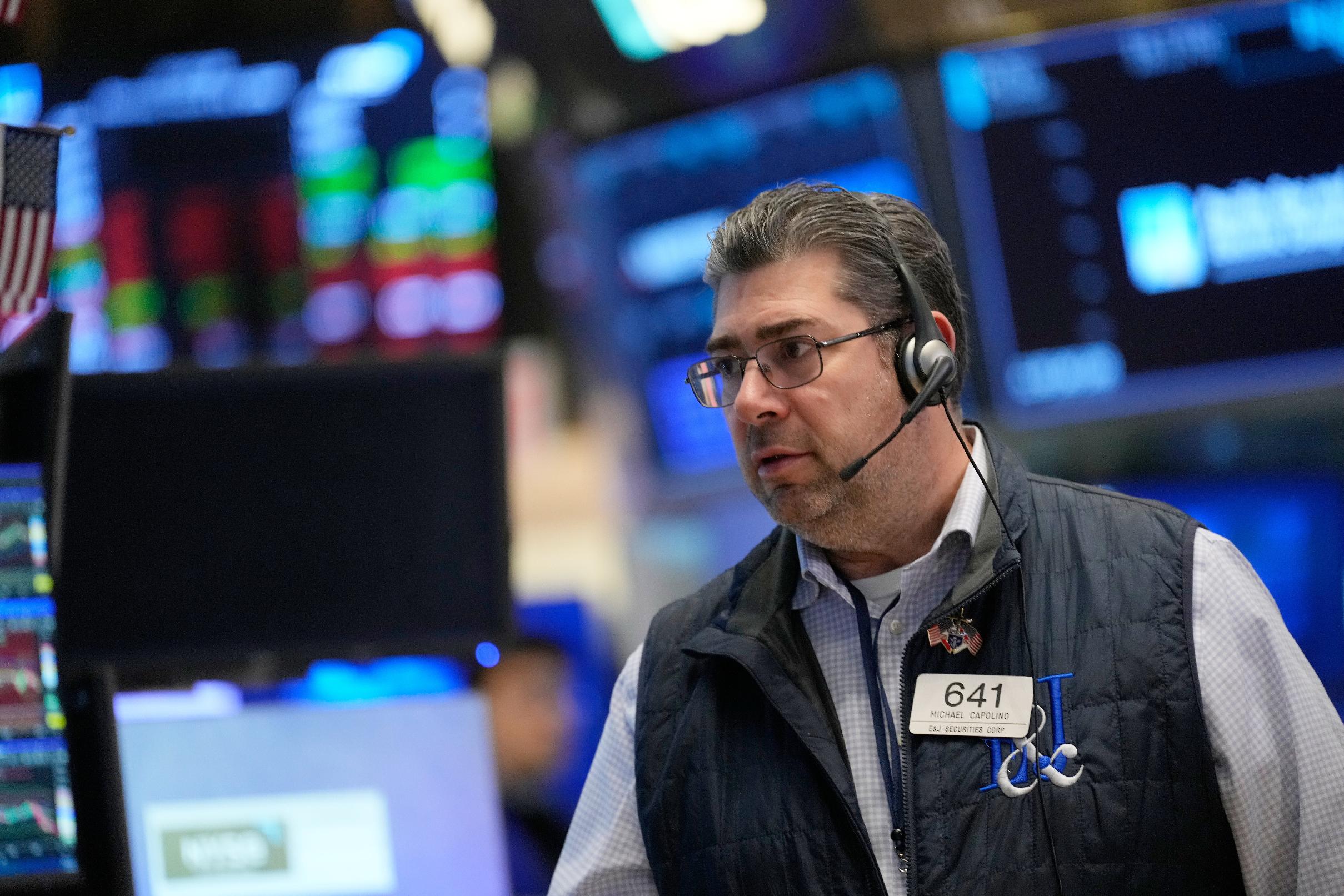Michael Capolino works on the floor at the New York Stock Exchange in New York, Thursday, March 19, 2026. (AP Photo/Seth Wenig)