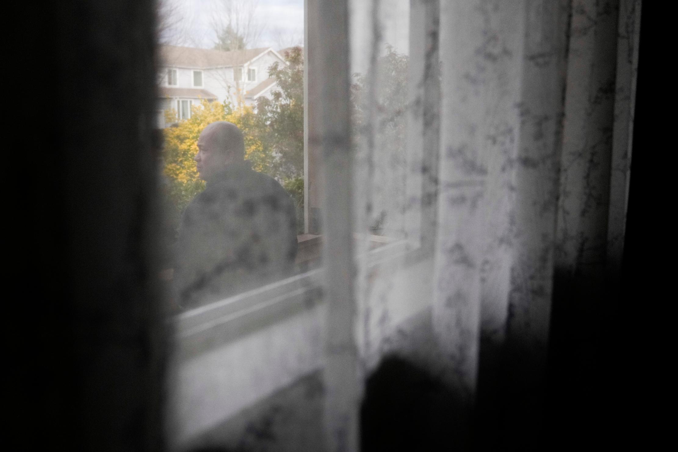 Seafarer Richard Zambales stands on the porch of a temporary rental house in Lacey, Wash., on Tuesday, Jan. 30, 2024. While waiting for backpay, stuck in the U.S., Zambales wasn’t sure he would be able to pay for his wife’s heart medication. (AP Photo/Lindsey Wasson)