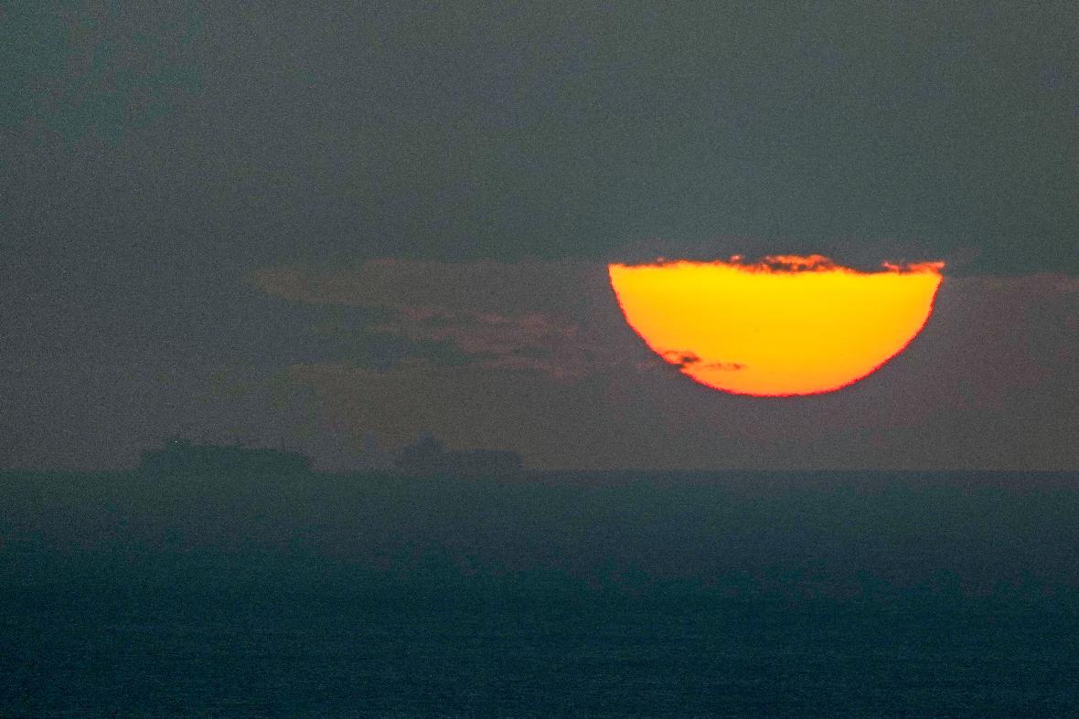FILE - Ships sail through the Arabian Gulf toward the Strait of Hormuz as the sun sets in the United Arab Emirates Monday, March 23, 2026. (AP Photo, File)