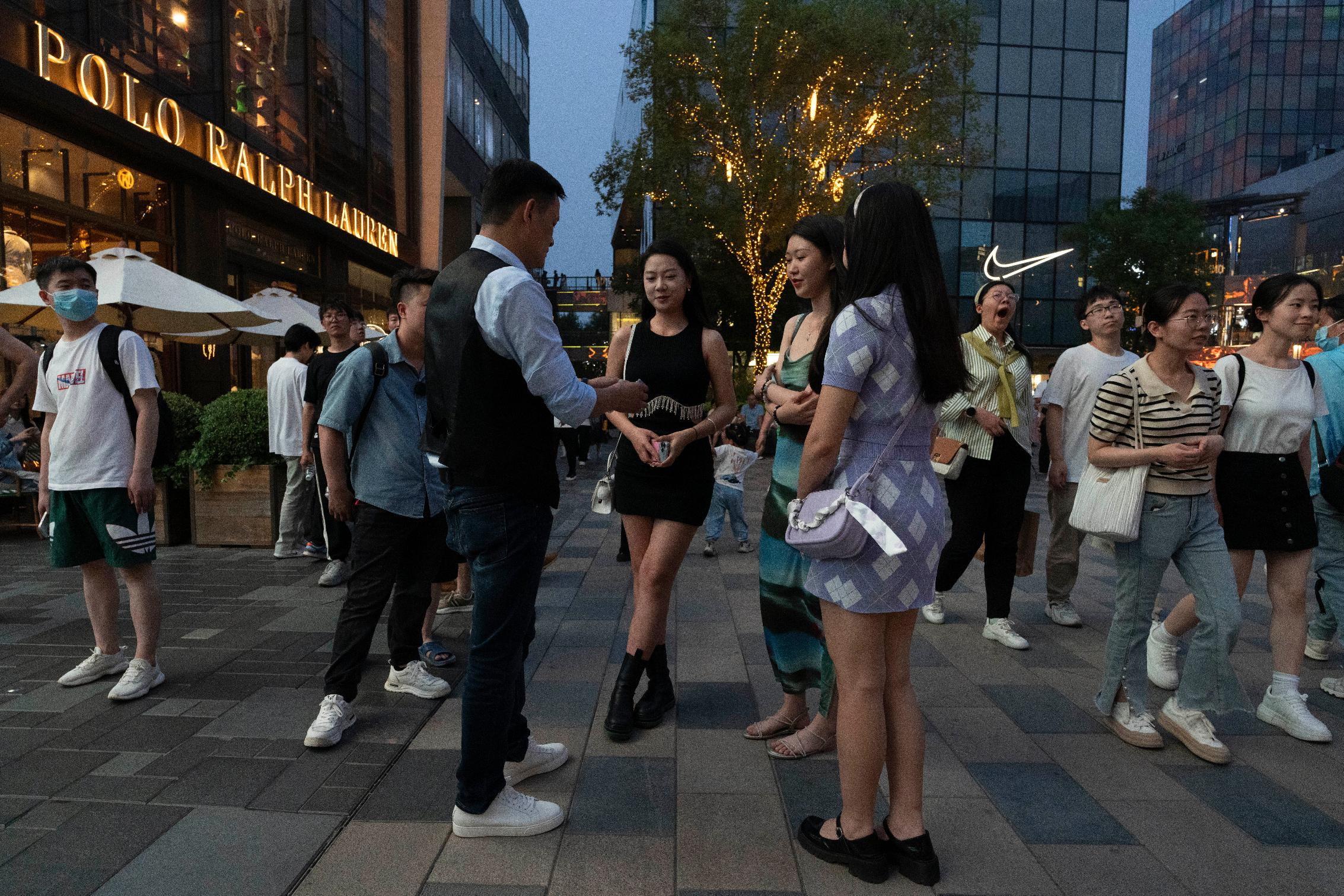 Shoppers visit a popular mall in Beijing, Sunday, June 18, 2023. Chinese consumers snapped up billions worth of items in China's first major online shopping festival after emerging from the pandemic as merchants slashed prices, but analysts say that consumer confidence still remains weak. (AP Photo/Ng Han Guan)