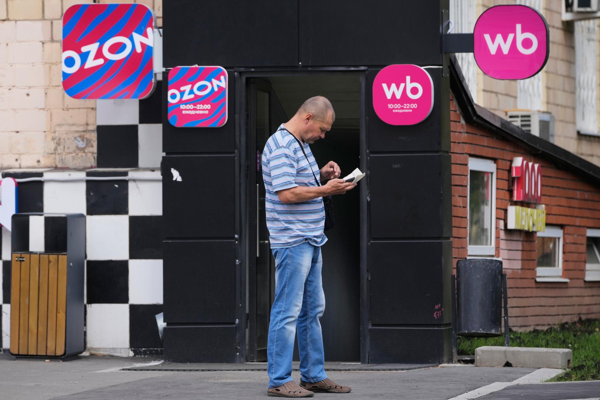 A man stands outside an outlet of Wildberries, Russia's major online retailer, in Moscow on Wednesday, July 22, 2026. (AP Photo/Pavel Bednyakov)