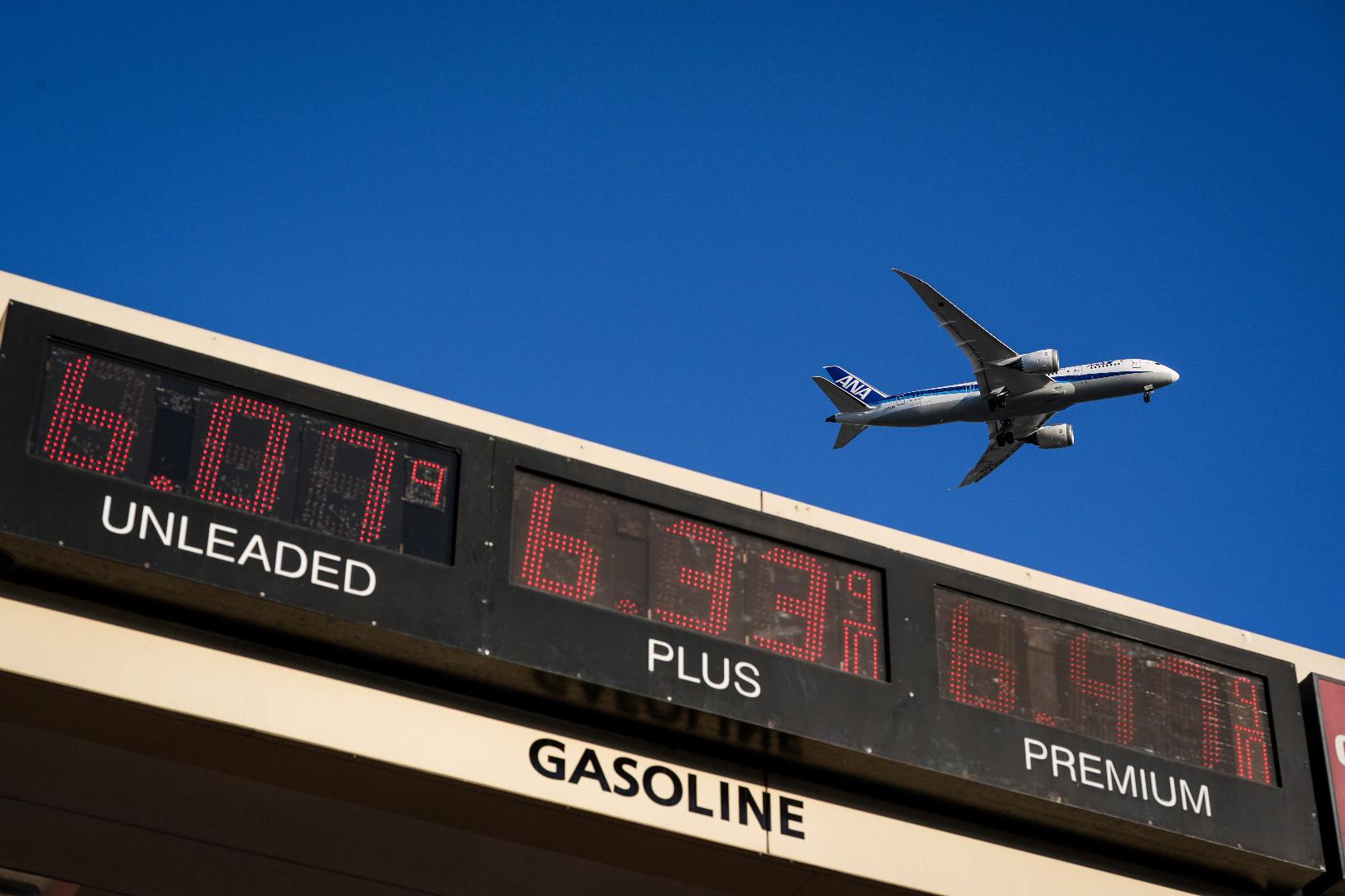FILE - An ANA jet flies above a gas station in Inglewood, Calif., on May 6, 2026. (AP Photo/Jae C. Hong, File)