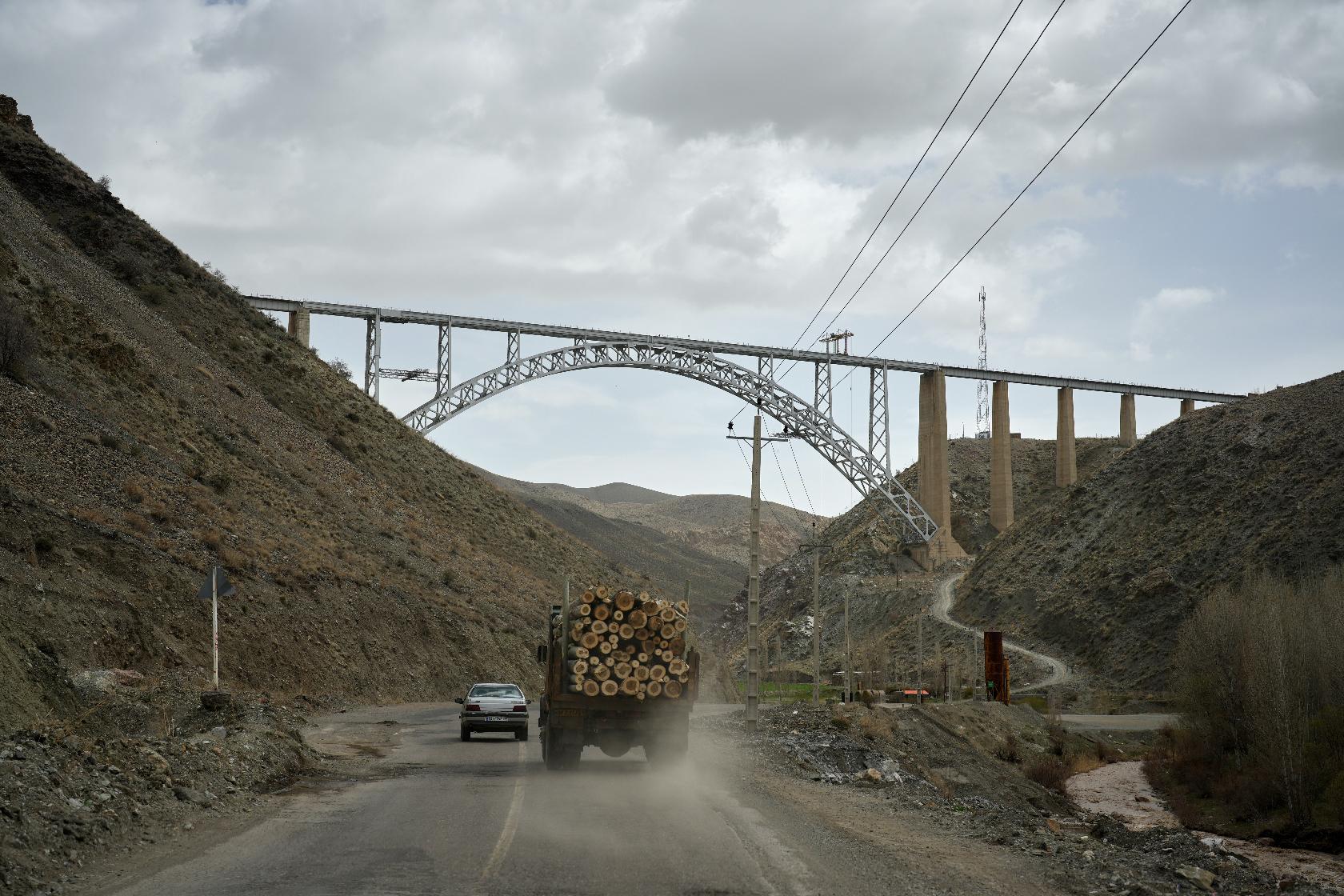 A truck loaded with logs and other vehicles drive along a road toward Tehran near the Turkish border on the outskirts of Razi, northwestern Iran, Saturday, April 4, 2026. (AP Photo/Francisco Seco)