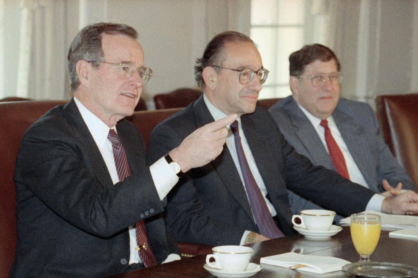 FILE - President George Bush gestures while meeting with economic advisors in the Cabinet Room of the White House, Jan. 15, 1991. Federal Reserve Board Chairman Alan Greenspan, center, and White House Chief of Staff John Sununu look on. (AP Photo/Doug Mills, file)