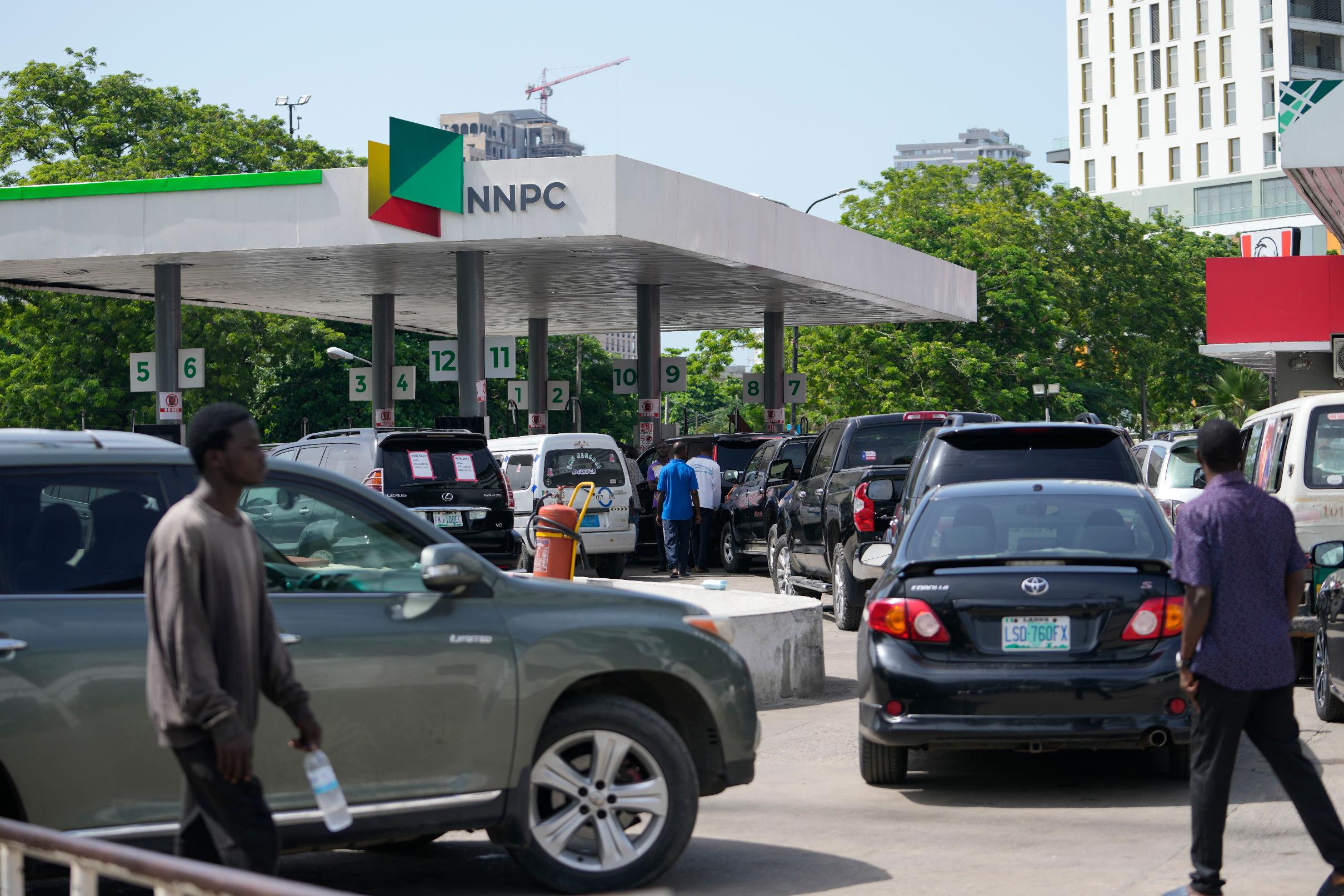 People queue to buy fuel at a petrol station in Lagos, Nigeria, Tuesday, May 30, 2023. Nigerian President Bola Tinubu has scrapped a decadeslong government-funded subsidy that has helped reduce the price of gasoline, leading to long lines at fuel stations Tuesday as drivers scrambled to stock up before costs rise. (AP Photo/Sunday Alamba)
