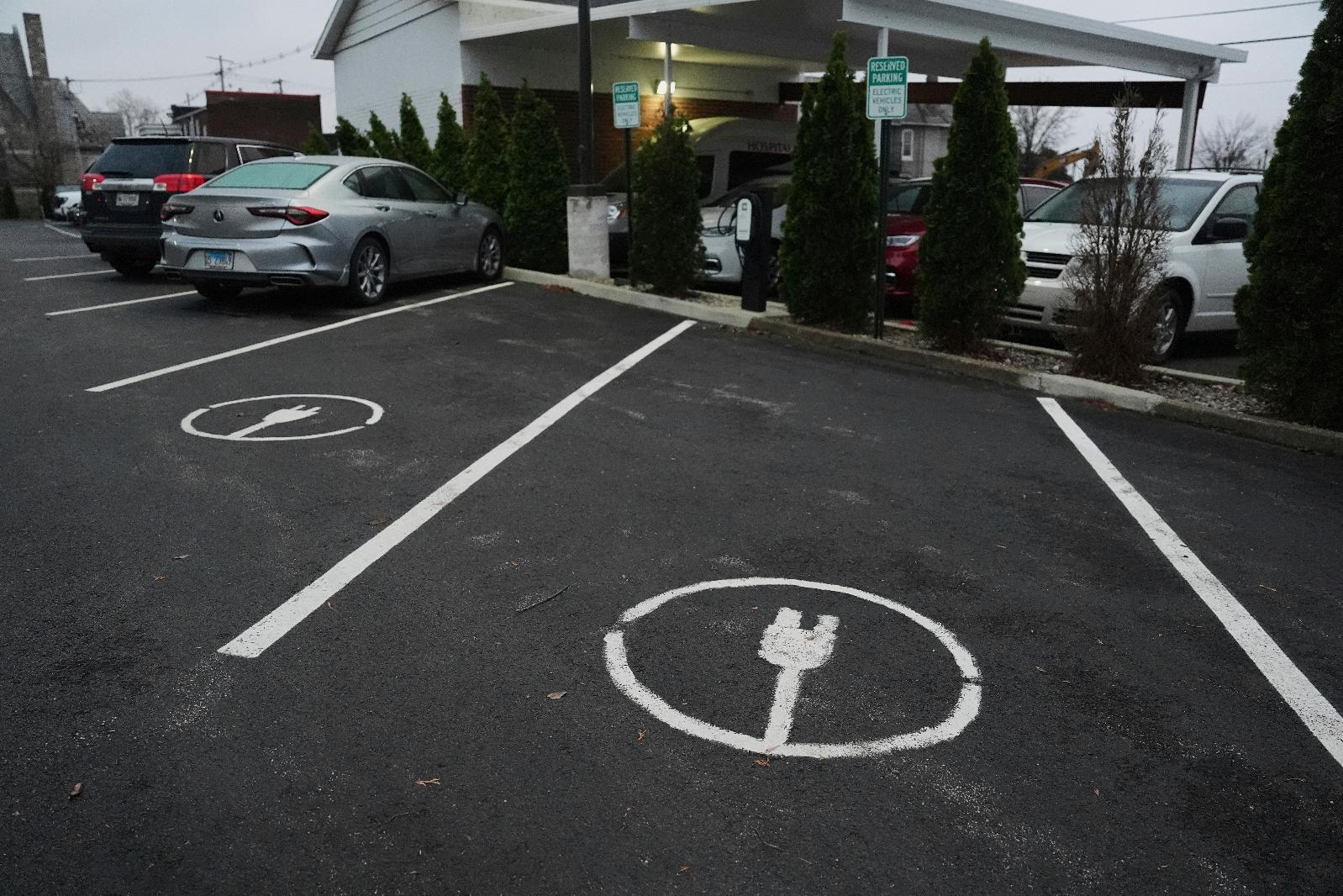 FILE - Electric vehicle parking spots sit near charging stations April 11, 2025, in Evansville, Ind. (AP Photo/Joshua A. Bickel, File)