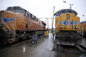 FILE - A Union Pacific worker walks between two locomotives that are being serviced in a railyard in Council Bluffs, Iowa, on Dec. 15, 2023. (AP Photo/Josh Funk, File)