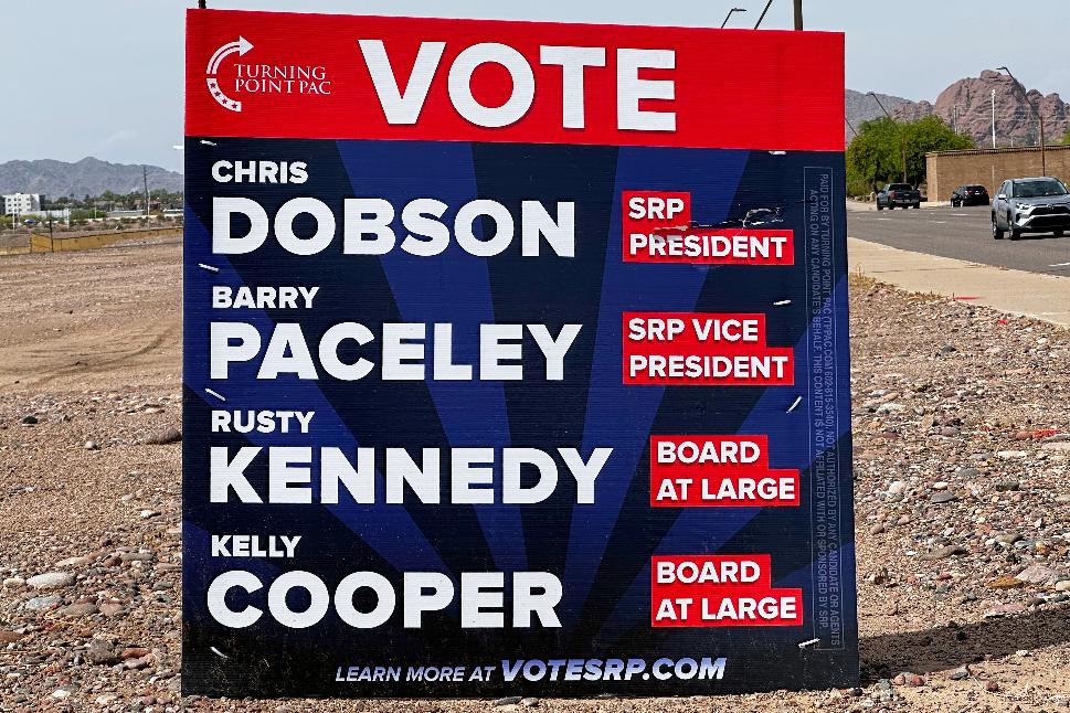A sign supporting candidates for the Salt River Project board sits next to an intersection Monday, March 30, 2026 in Tempe, Ariz. (AP Photo/Jonathan J. Cooper)