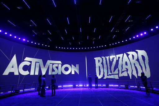 FILE - The Activision Blizzard Booth is shown on June 13, 2013 the during the Electronic Entertainment Expo in Los Angeles. Microsoft is buying Activision Blizzard, Tuesday, Jan. 18, 2022,  for $68.7 billion to gain access to blockbuster games including Call of Duty and Candy Crush. The all-cash deal will let Microsoft accelerate mobile gaming and provide it building blocks for the metaverse, or a virtual environment.  (AP Photo/Jae C. Hong, File)