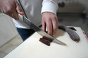 Misa Rajic prepares ironed sausage at his home in Pirot, Serbia, on Feb. 13, 2026. (AP Photo/Darko Vojinovic)