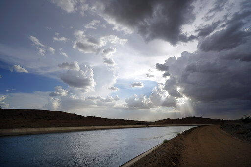 FILE - Water flows along the All-American Canal Saturday, Aug. 13, 2022, near Winterhaven, Calif. The canal conveys water from the Colorado River into the Imperial Valley. California water agencies that rely on the Colorado River, said Wednesday, Oct 5, 2022, that they can reduce their use by up to 400,000 acre feet annually, an amount that's roughly one-tenth of the river water the state receives. (AP Photo/Gregory Bull, File)