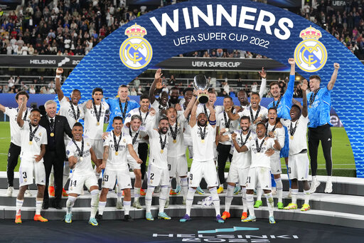 Real Madrid's Karim Benzema lifts the trophy after winning the UEFA Super Cup final soccer match between Real Madrid and Eintracht Frankfurt at Helsinki's Olympic Stadium, Finland, Wednesday, Aug. 10, 2022. Real Madrid won 2-0. (AP Photo/Antonio Calanni)