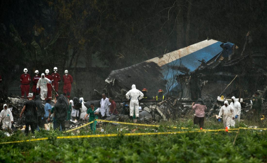 FILE - Rescue teams search through the wreckage site of a Boeing 737 that plummeted into a cassava field with more than 100 passengers on board, in Havana, Cuba, May 18, 2018 . (AP Photo/Ramon Espinosa, File)
