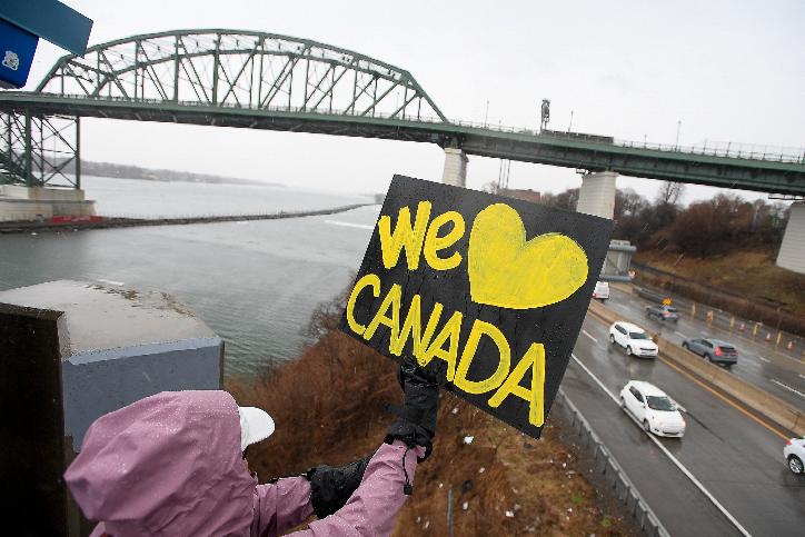 Elbows Up for Canada protesters gather near The Peace Bridge border crossing in Buffalo, N.Y., Wednesday, April 2, 2025. (AP Photo/Adrian Kraus)