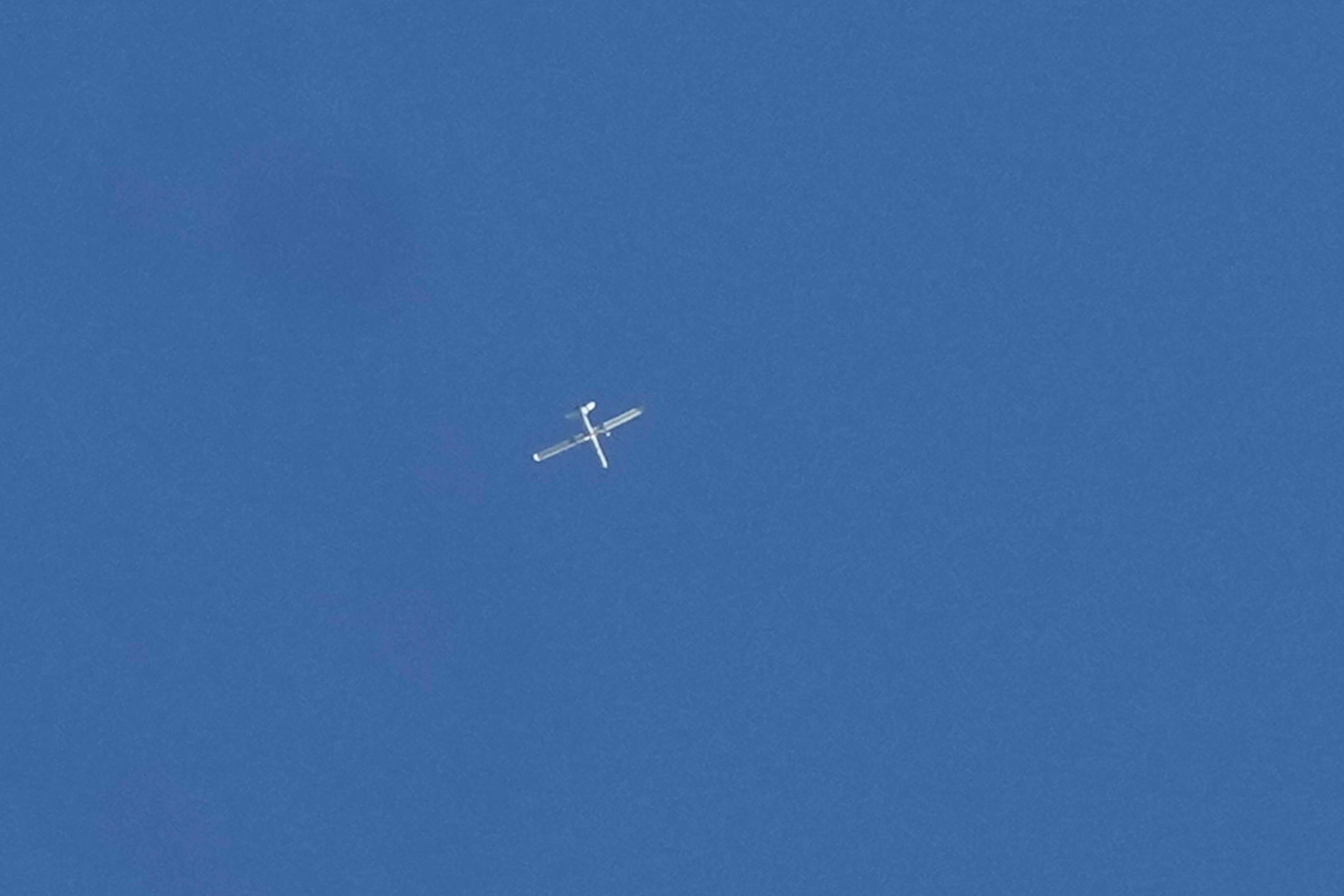 FILE - An Israeli reconnaissance drone flies over the funeral procession of four Hezbollah fighters who were killed a day earlier after their handheld devices exploded in the southern suburb of Beirut, on Wednesday, Sept. 18, 2024. (AP Photo/Bilal Hussein, File)