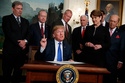FILE - President Donald Trump speaks before he signs a presidential memorandum imposing tariffs and investment restrictions on China in the Diplomatic Reception Room of the White House, March 22, 2018, in Washington. (AP Photo/Evan Vucci, File)