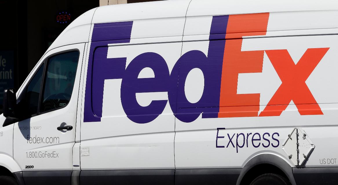 FILE - A Fed Ex truck sits during a delivery June 26, 2019, in Chapel Hill, N.C. (AP Photo/Gerry Broome, File)