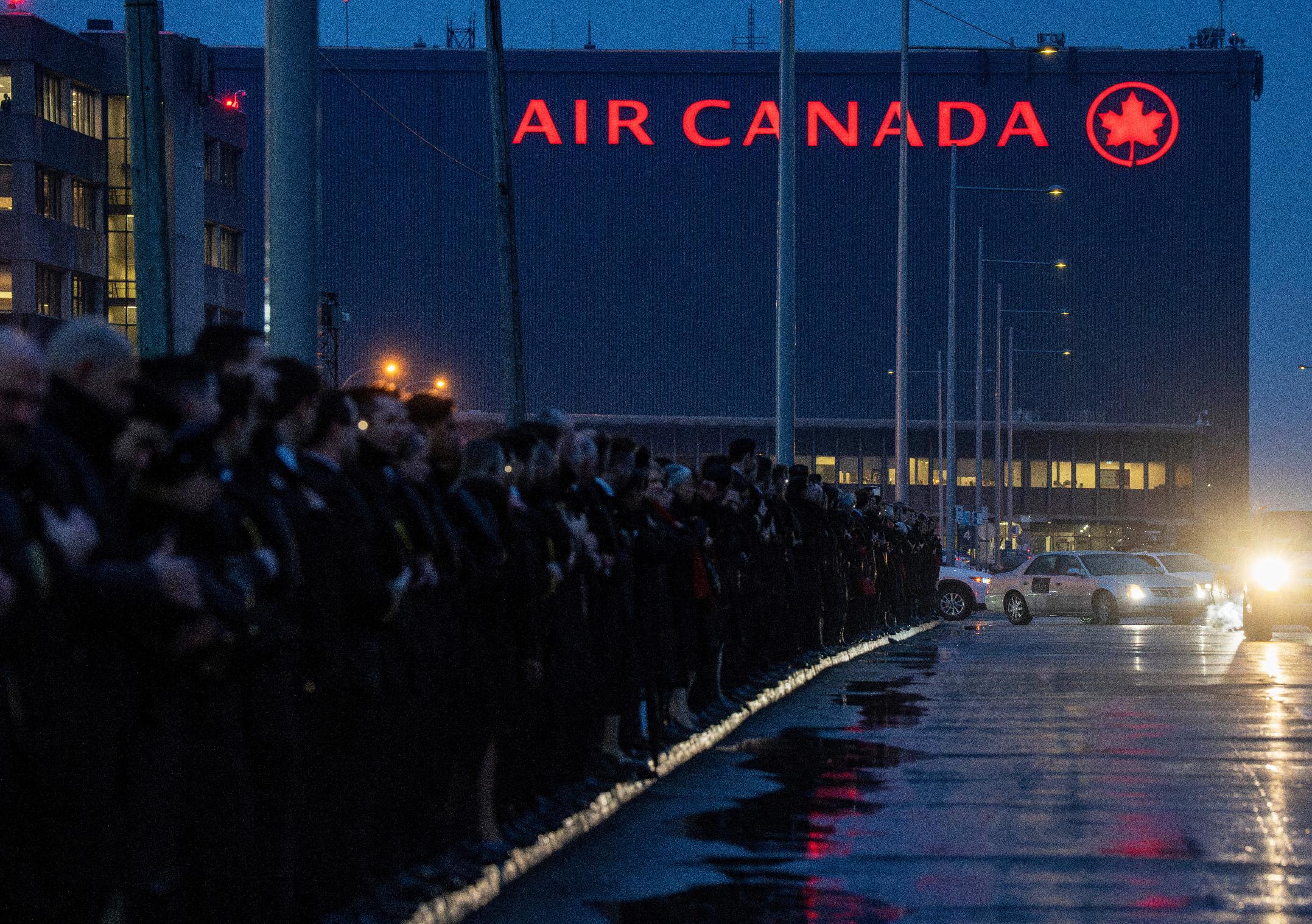 A procession for Air Canada Jazz pilot Antoine Forest, who died Sunday when his plane collided with an emergency vehicle at New York's LaGuardia Airport, leaves Air Canada headquarters, in Montreal, Thursday, March 26, 2026. (Christinne Muschi/The Canadian Press via AP)