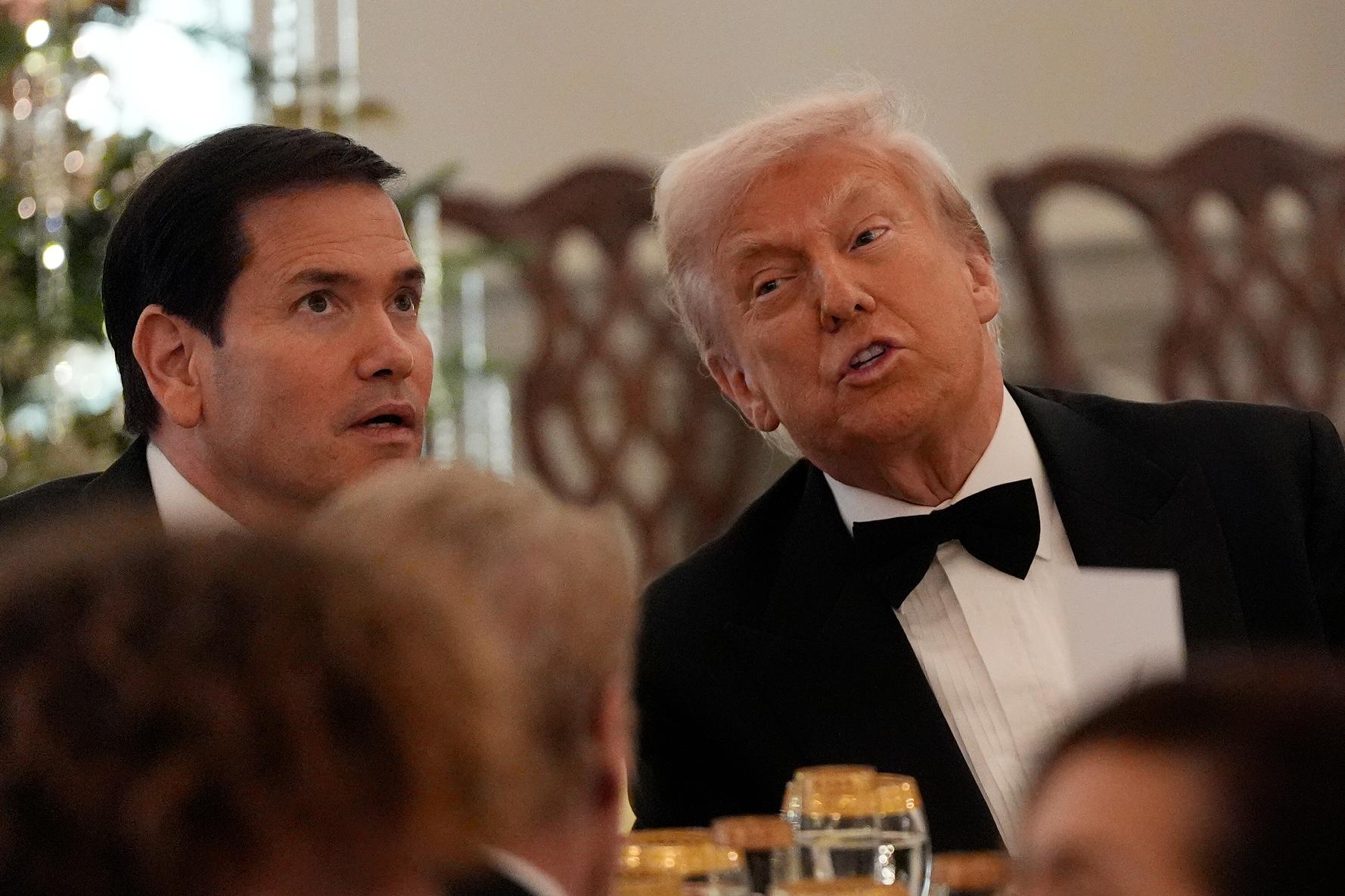 President Donald Trump, right, seated with Sec. of State Marco Rubio, left, at a Kennedy Center Honors reception for recipients at the State Department, Saturday, Dec. 6, 2025, in Washington. (AP Photo/Julia Demaree Nikhinson)