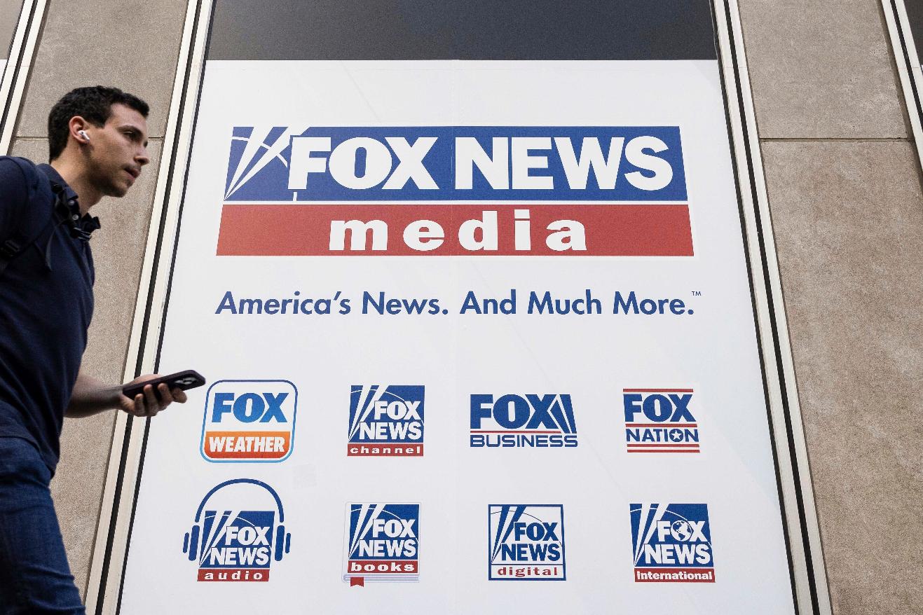 FILE - A person walks past the Fox News Headquarters in New York on April 12, 2023. (AP Photo/Yuki Iwamura, File)