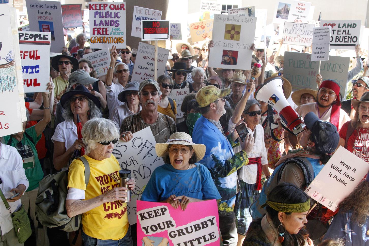Hundreds of people protest efforts to privatize federal public land in Santa Fe, N.M., outside a meeting of governors from western states and top Trump-administration officials as Agriculture Secretary Brooke Rollins announced plans to rescind a decades-old rule that blocked logging on national forest lands, in Santa Fe, N.M., Monday, June 23, 2025. (AP Photo/Morgan Lee)