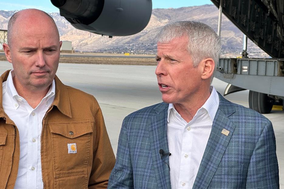 Energy Secretary Chris Wright, right, speaks as Utah Gov. Spencer Cox listens, following a news conference at Hill Air Force Base, Utah. Wright and other officials were onboard as a Valar Atomics microreactor, without nuclear fuel, was transported from March Air Reserve Base in California to Hill Air Force Base. Cox met the plane in Utah. (AP Photo/Matthew Daly)