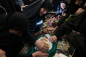 The mother of Jawad Younes,11, who was killed on Friday in an Israeli airstrike, mourns over his body during a funeral procession in Saksakiyeh village, south Lebanon, Saturday, March 28, 2026. (AP Photo/Hussein Malla)