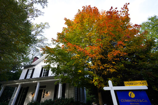 A real estate sign is seen near a home on the market, Wednesday, Oct. 12, 2022, in Towson, Md. Any Americans hoping for relief from months of punishing inflation might not see much in an upcoming government report on price increases in September. (AP Photo/Julio Cortez)
