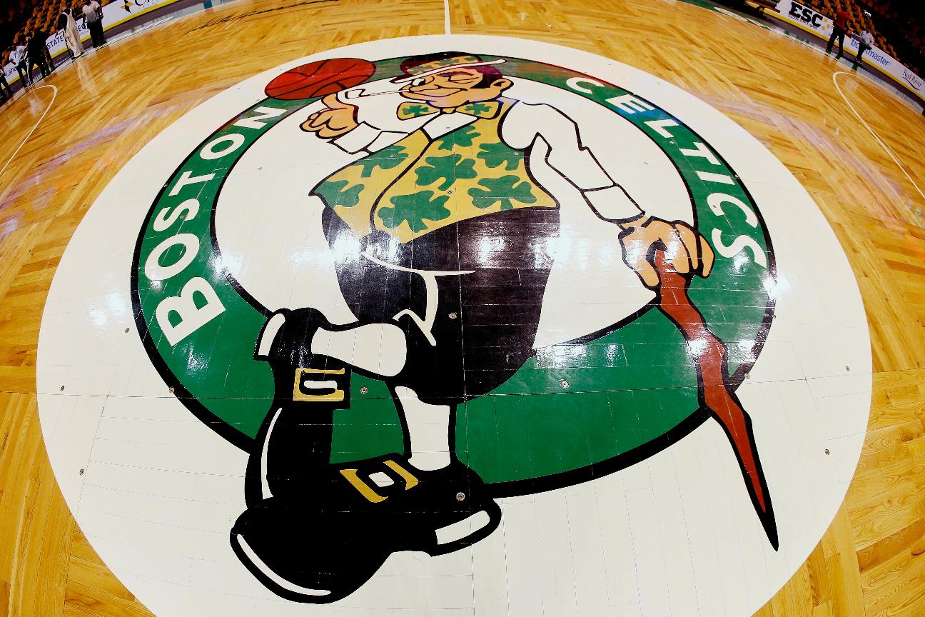 FILE - In this image taken with a fisheye lens, the Boston Celtics logo is seen at center court on the parquet floor before before taken up for a Boston Bruins NHL hockey game later in the day, Sunday, April 8, 2018, in Boston. (AP Photo/Winslow Townson, File)