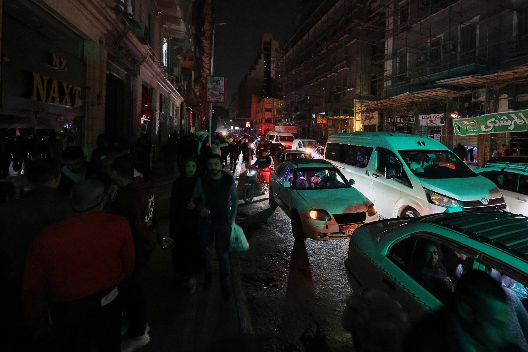 Vehicles drive as light poles are switched off to save electricity, as part of a series of measures the government has taken to mitigate the fallout of the U.S. and Israeli war against Iran, in Cairo, Egypt, Saturday, March 28, 2026. (AP Photo/Khaled Elfiqi)