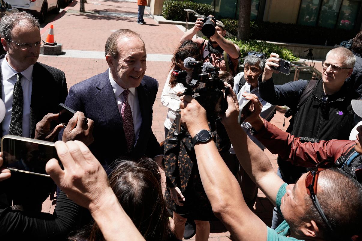 Steven F. Molo, attorney for Elon Musk, second from left, speaks to reporters outside the U.S. District Court, Monday, May 18, 2026, in Oakland, Calif. (AP Photo/Nathan Weyland)