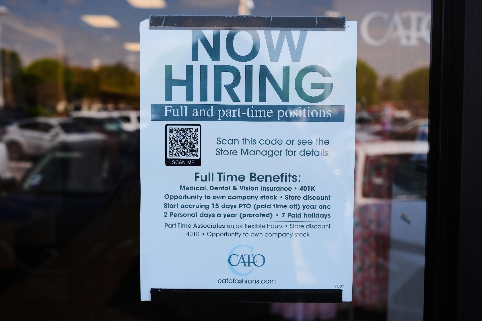 A now hiring sign sits on the window of a retail clothing store in Garland, Texas, Monday, March 23, 2026. (AP Photo/LM Otero)