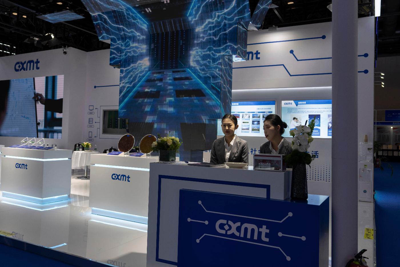 FILE - Workers at the booth for Chinese DRAM producer ChangXin Memory Technologies, also known as CXMT, wait for visitors at the 21st China International Semiconductor Expo in Beijing, Nov. 20, 2024. (AP Photo/Ng Han Guan, File)